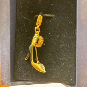 Swarovski crystal and gold toned high heel pendant.